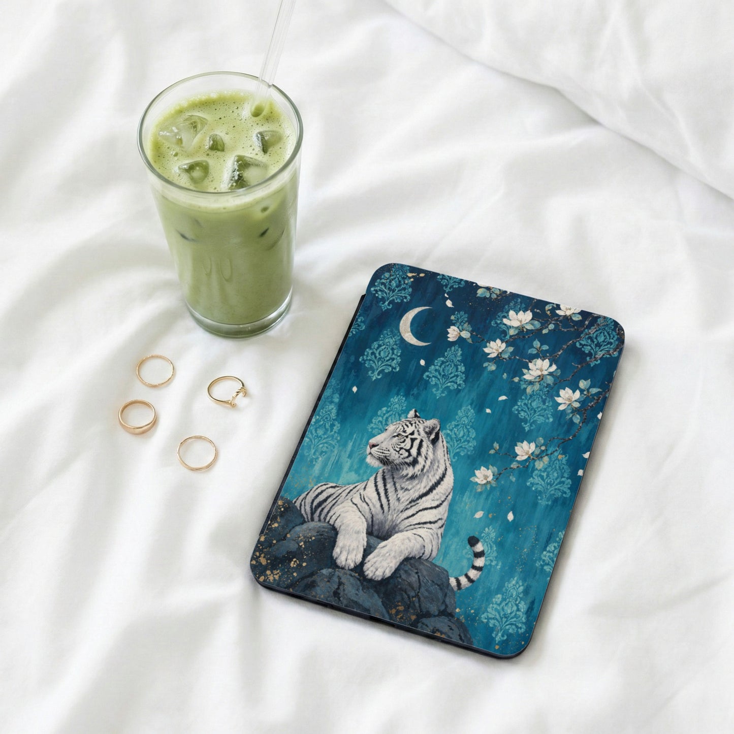 Tablet case with white tiger design on a blue background with flowers and moon.