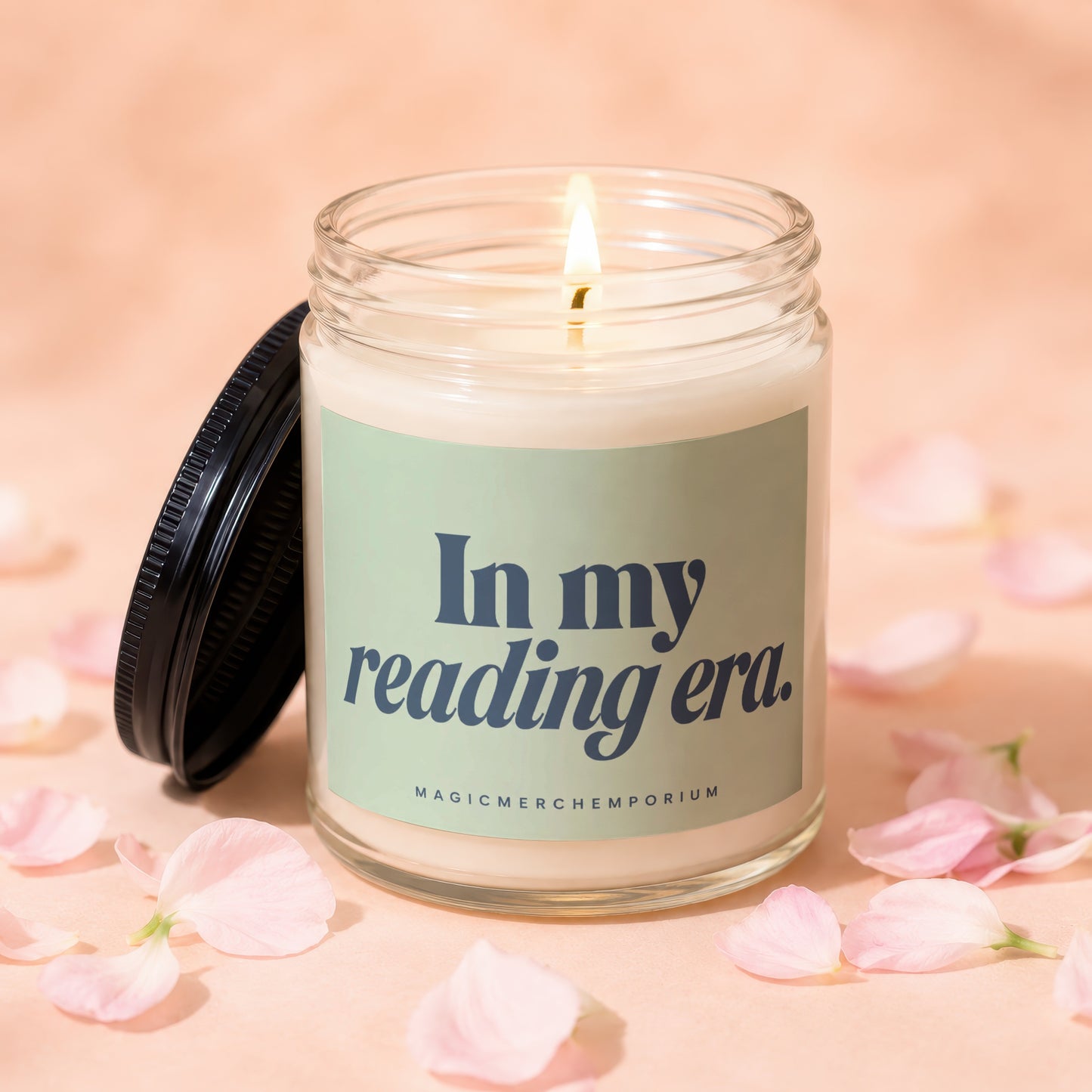 Candle with lid off, lit wick, and "In my reading era." text.