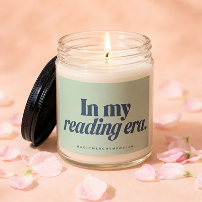 Candle with lid off, lit wick, and "In my reading era." text.