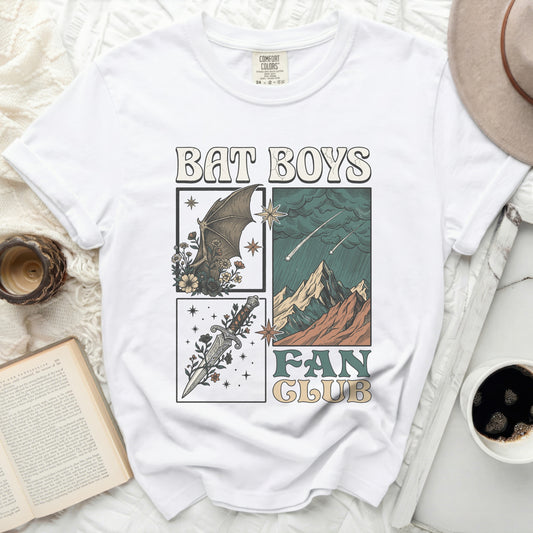 White t-shirt with "BAT BOYS FAN CLUB" graphic featuring a bat, dagger, and mountains.
