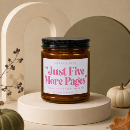 Amber candle in glass jar with text "Just Five More Pages" on label.