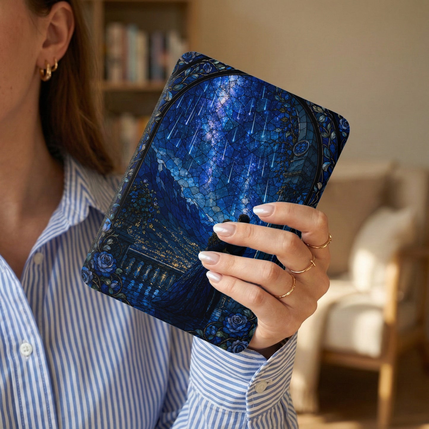 Woman holding a book with stained glass-style night sky and shooting stars.