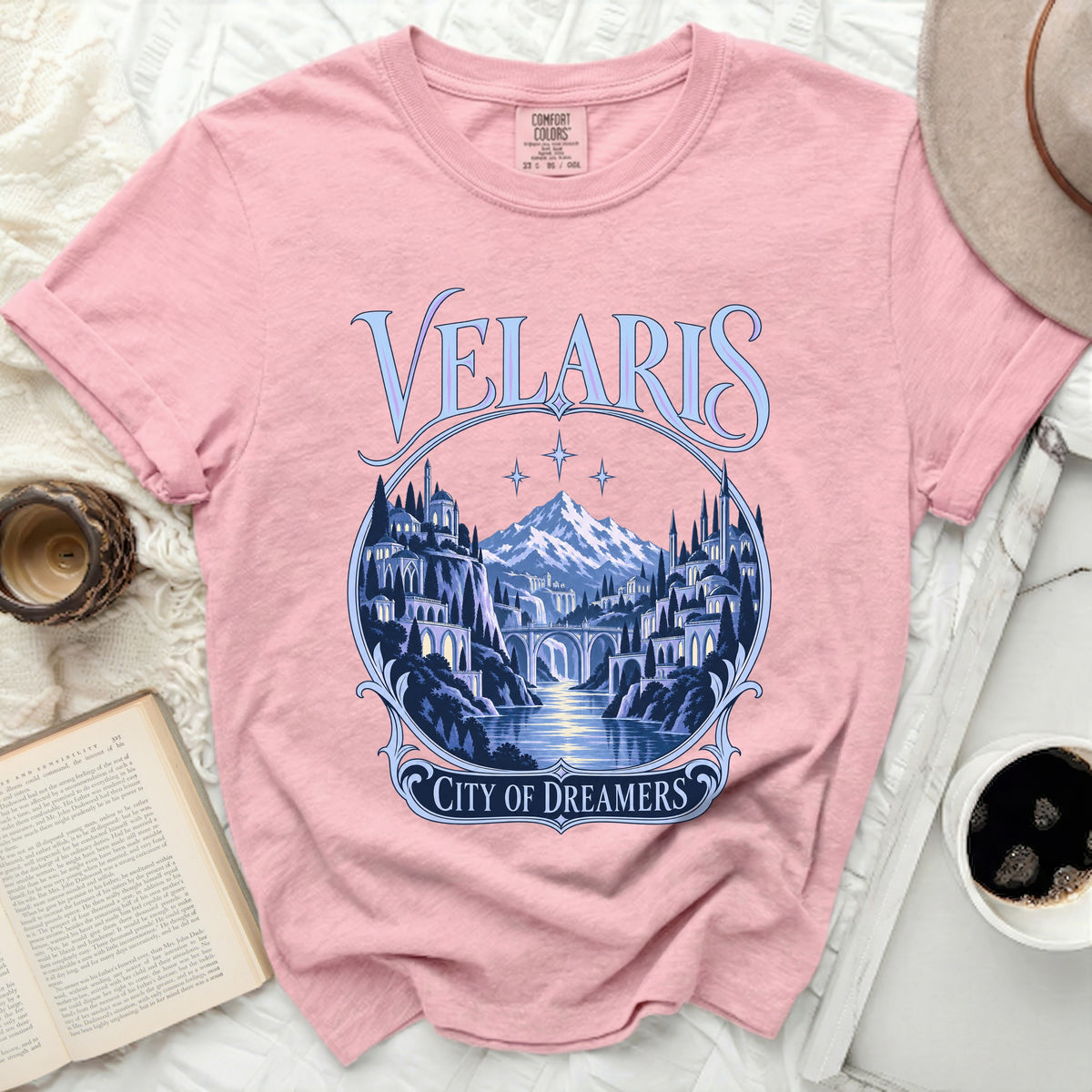 Pink t-shirt with "Velaris City of Dreamers" graphic featuring a fantasy city.