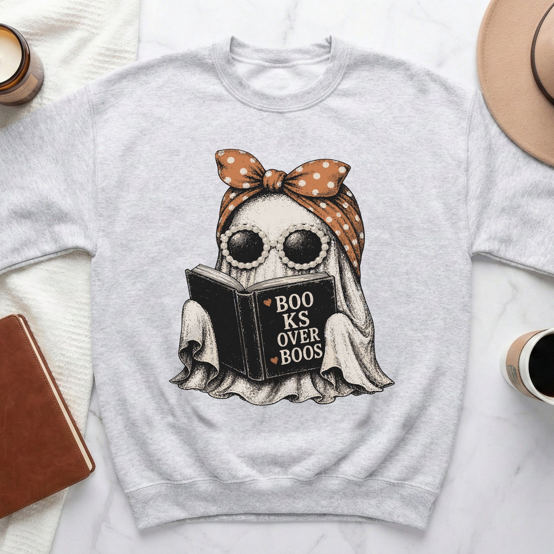 Ghost wearing sunglasses and bandana reads book with text "Books Over Boos".