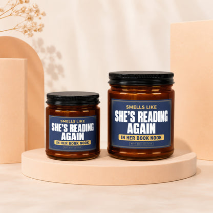 Two amber glass candles with "Smells Like She's Reading Again In Her Book Nook" labels.