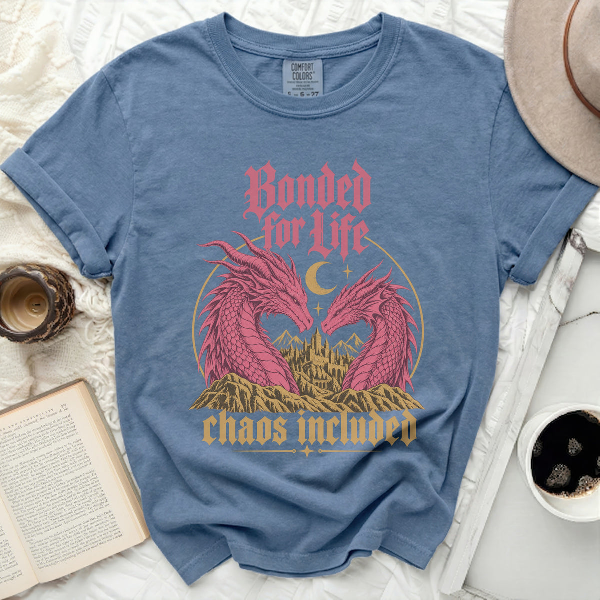 Blue t-shirt with pink dragons, castle, and text "Bonded for Life chaos included".