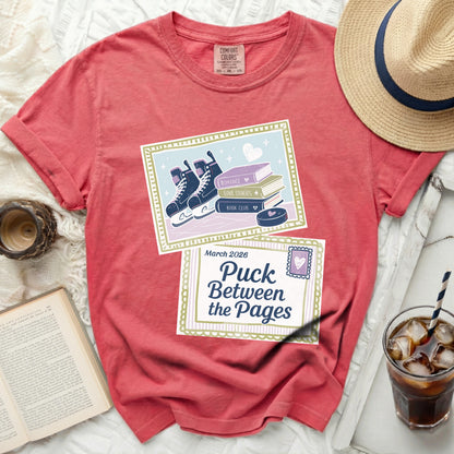 Red t-shirt with "Puck Between the Pages" graphic, roller skates, and books.
