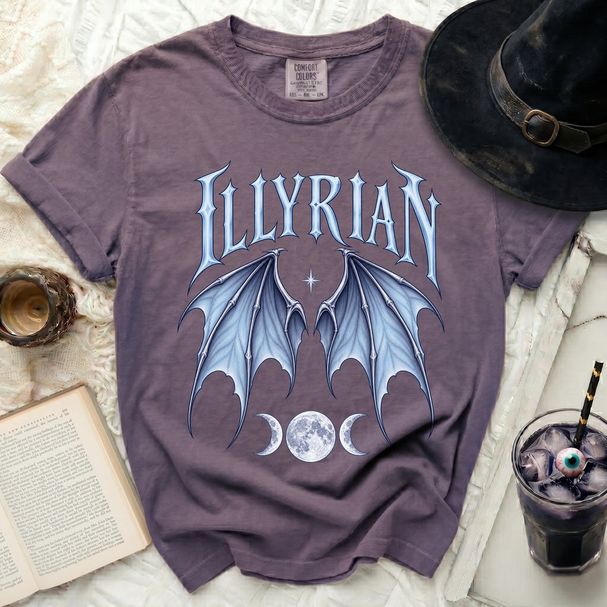 Purple t-shirt with "ILLYRIAN" text, bat wings, and moon phases graphic.