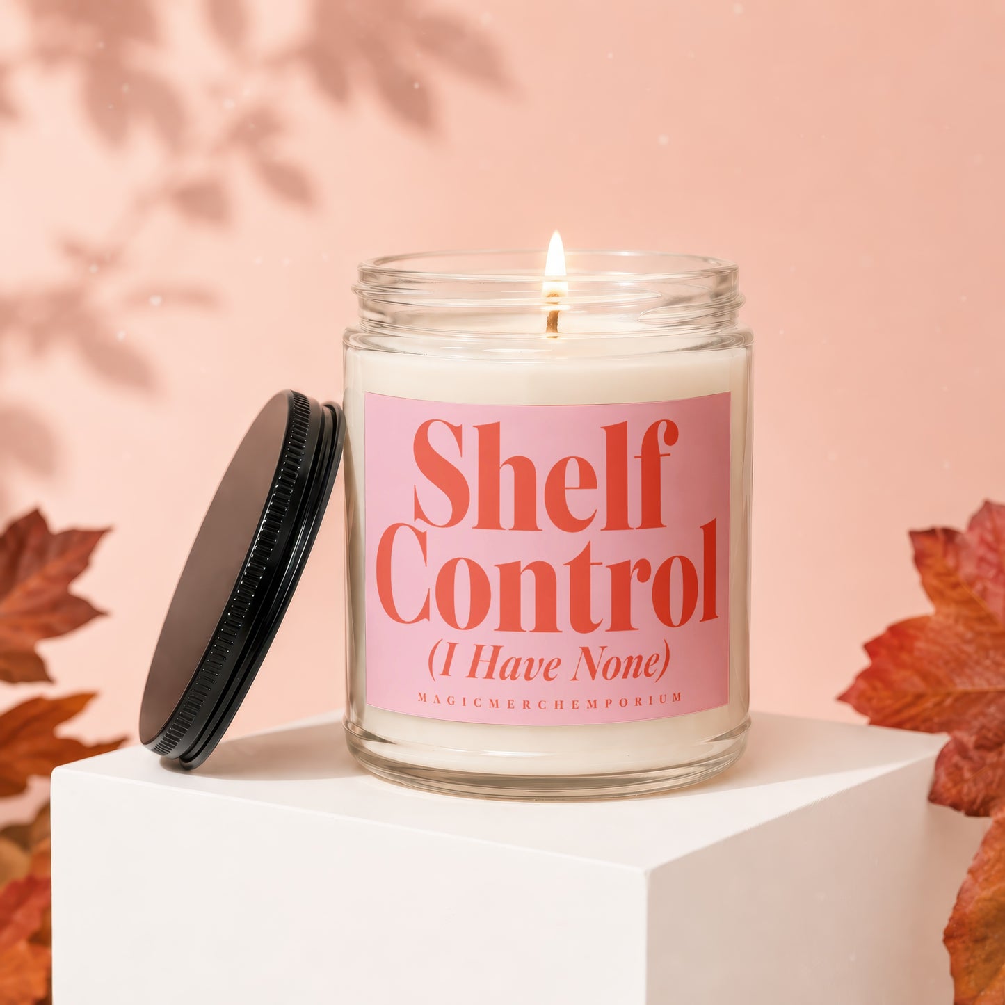 Glass candle with pink label reading "Shelf Control (I Have None)"