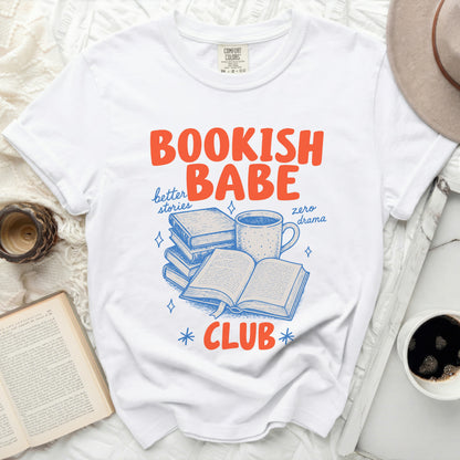 White t-shirt with "Bookish Babe Club" text and book illustrations.