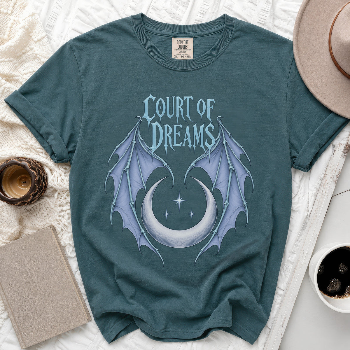 Teal t-shirt with "COURT OF DREAMS" text, wings, and moon graphic.
