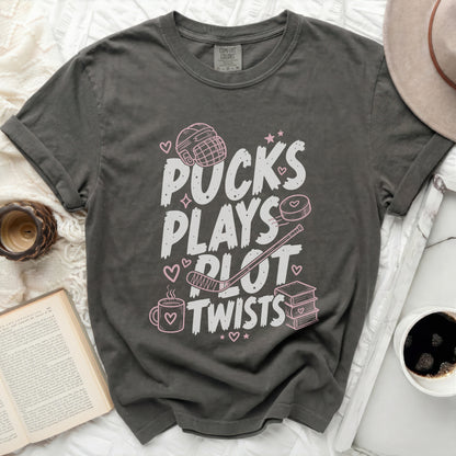 Gray t-shirt with "Pucks Plays Plot Twists" text and hockey graphics.