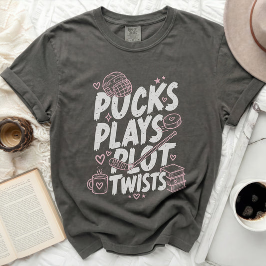 Gray t-shirt with "Pucks Plays Plot Twists" text and hockey graphics.