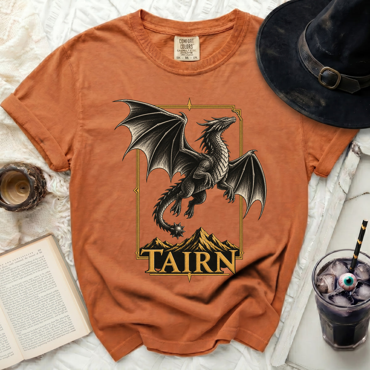 Orange t-shirt with a detailed dragon design and "TAIRN" text.