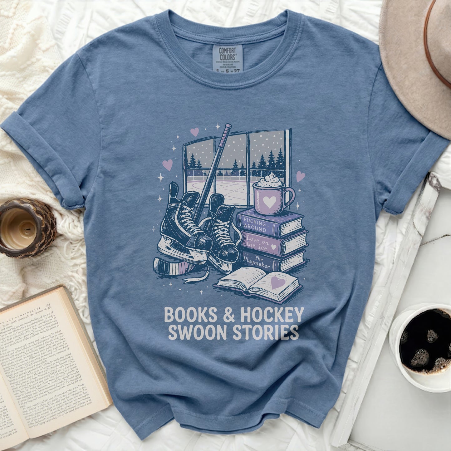 Blue t-shirt with ice skates, hockey puck, books, and "Books & Hockey Swoon Stories" text.