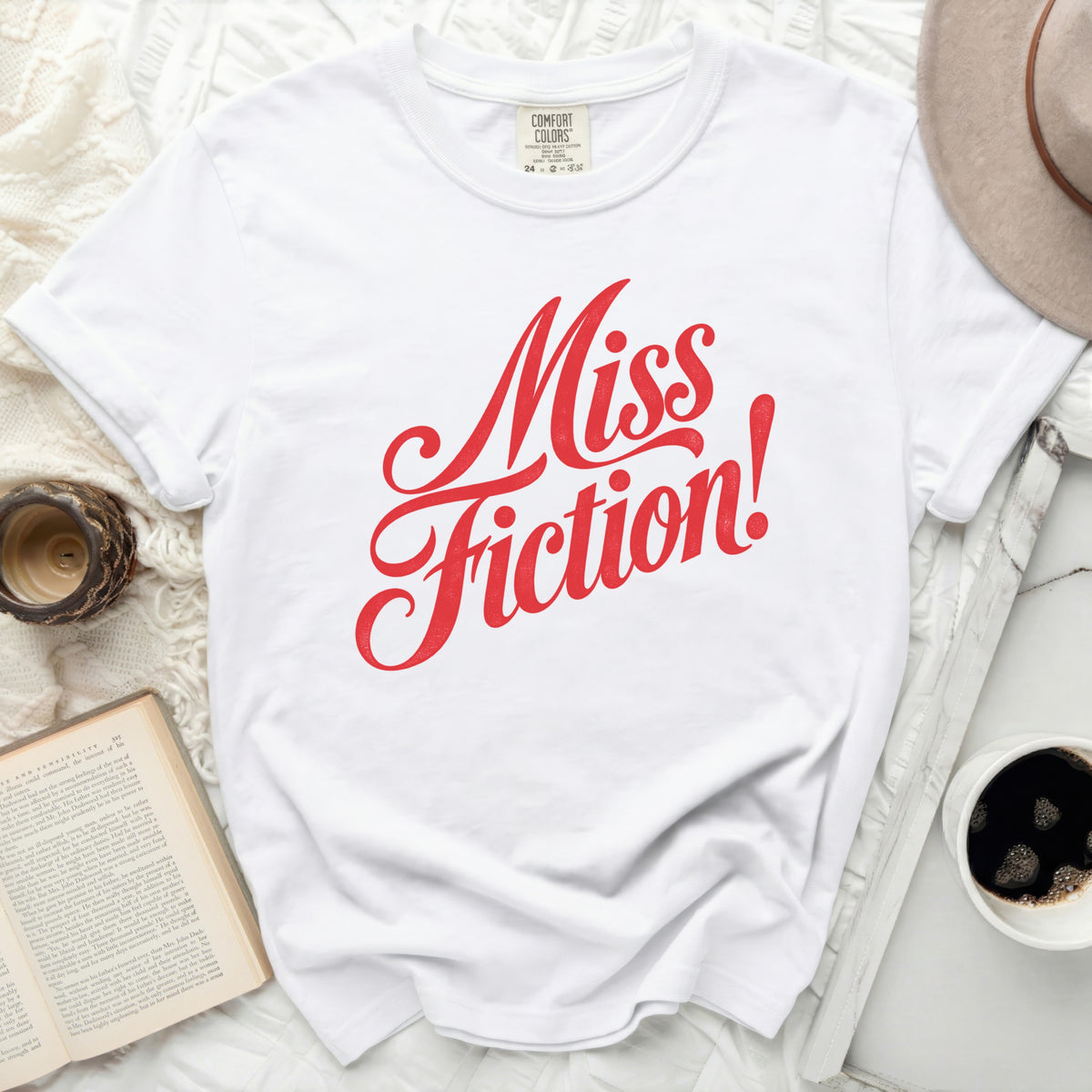 White t-shirt with red "Miss Fiction!" graphic text.