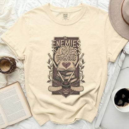 T-shirt with "The Enemies to Lovers Book Club" graphic and books.