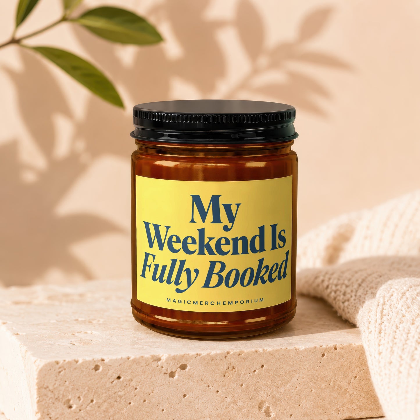 Amber jar candle with yellow label reading "My Weekend Is Fully Booked".