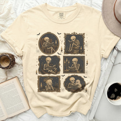 T-shirt with six framed illustrations of skeletons reading and holding books.