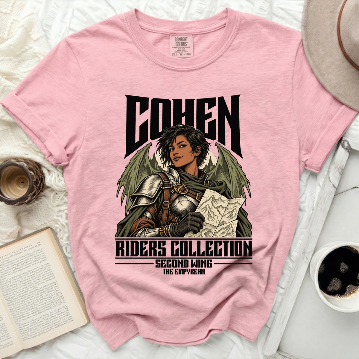 Pink t-shirt with "Cohen Riders Collection Second Wing The Empyrean" text and winged warrior art.