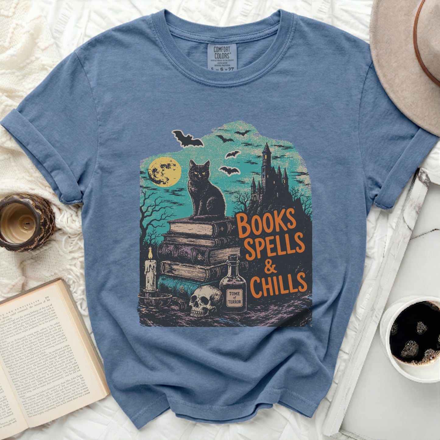 Black cat on books with "Books Spells & Chills" text and Halloween scene.