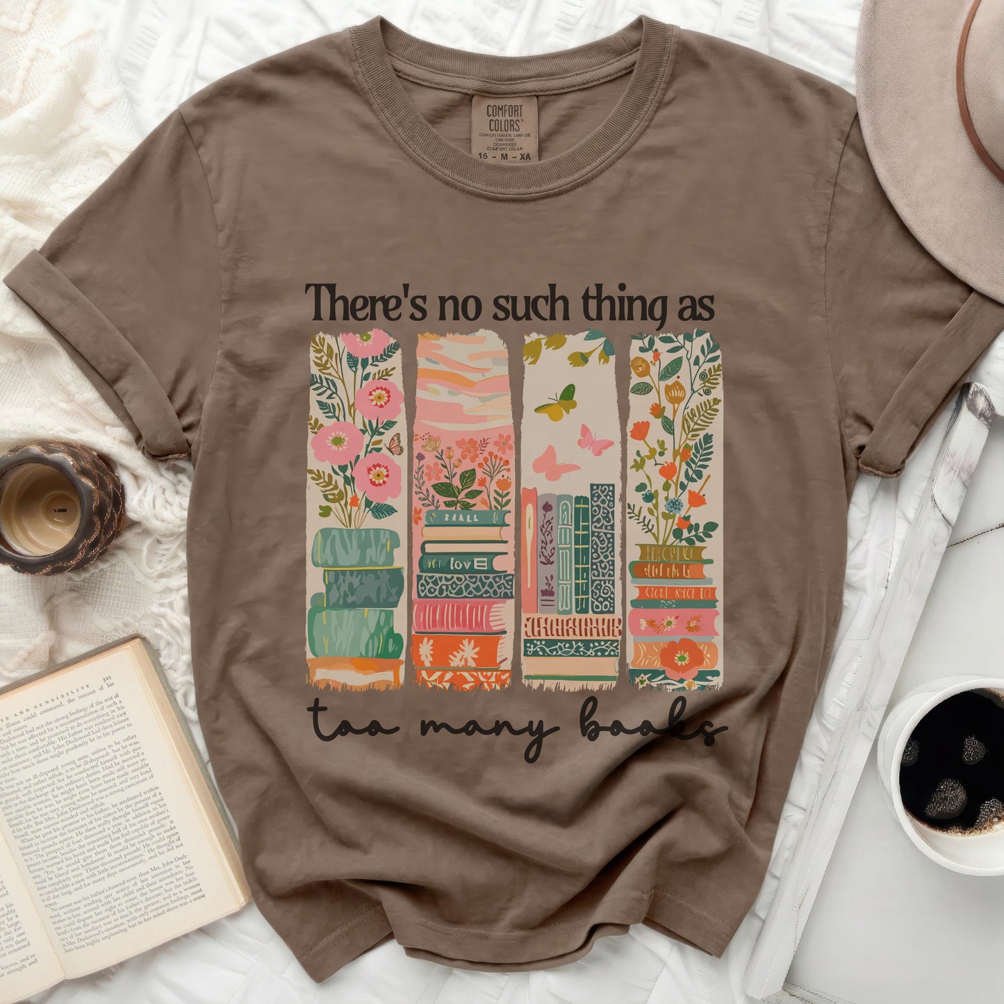 Brown t-shirt with a floral stack of books and "There's no such thing as too many books" text.