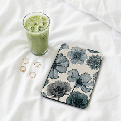 Floral patterned tablet cover with a glass of iced matcha latte and gold rings.