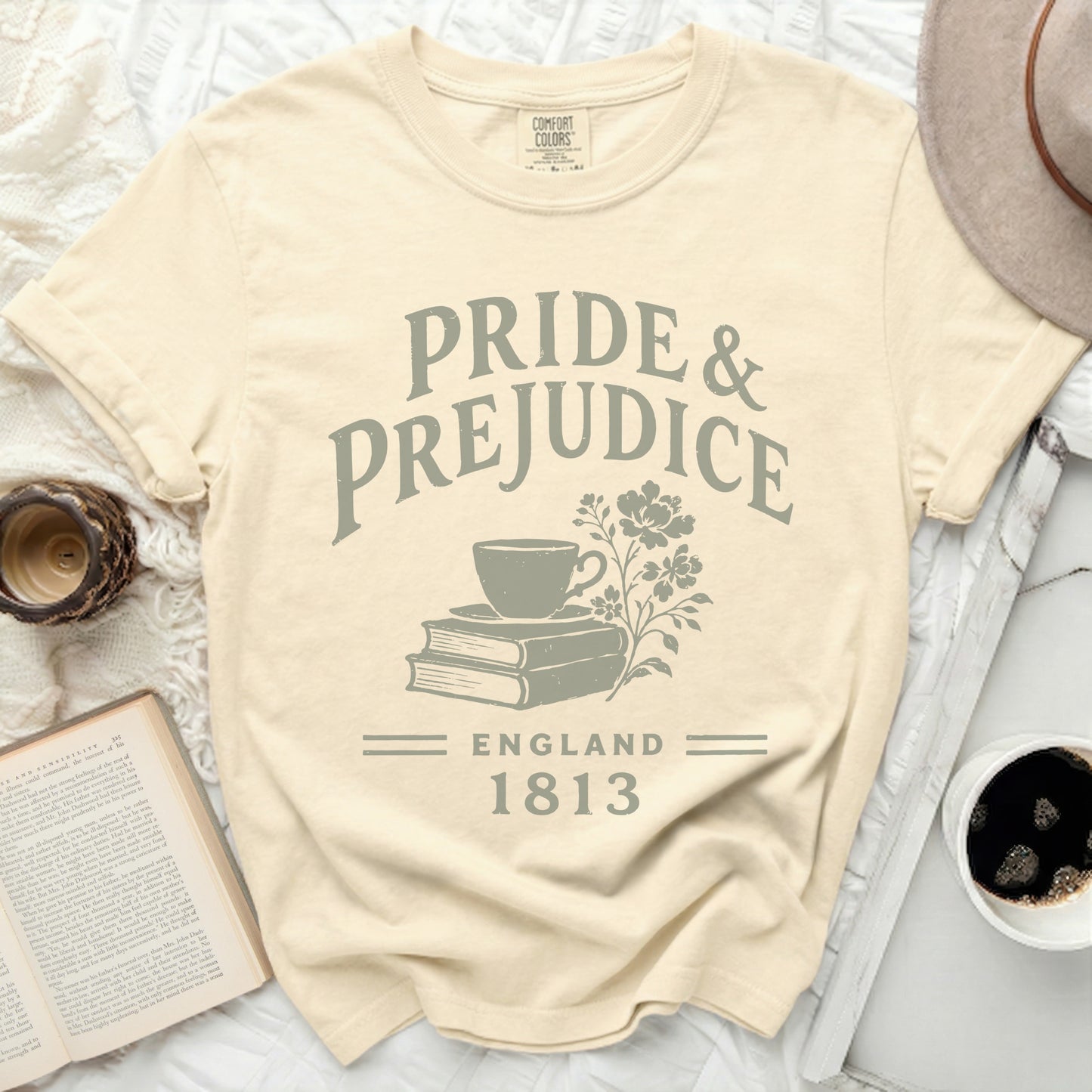 Cream t-shirt with "Pride & Prejudice, England 1813" text and floral design.