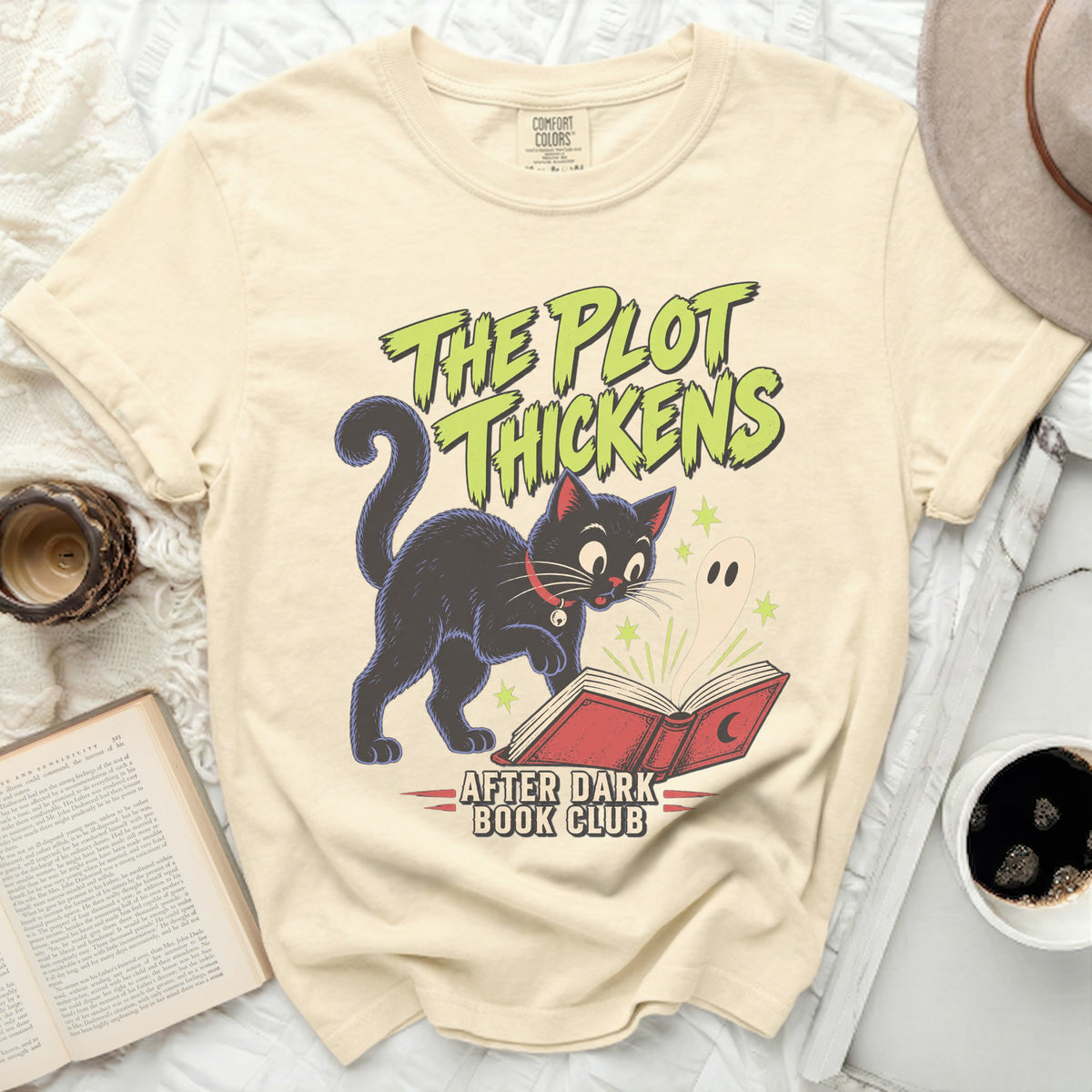 Black cat and ghost reading a book with "The Plot Thickens" and "After Dark Book Club" text.