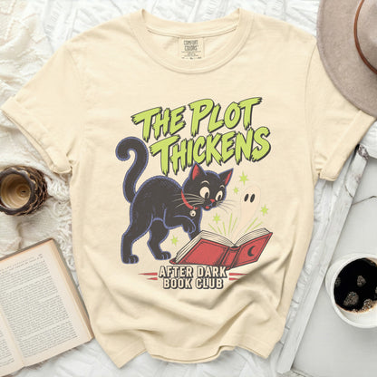 Black cat and ghost reading a book with "The Plot Thickens" and "After Dark Book Club" text.
