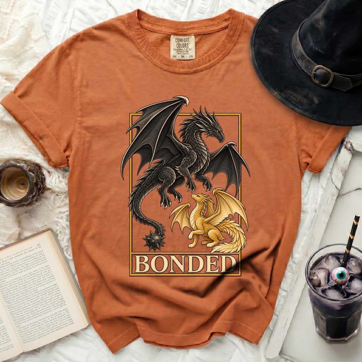 Orange t-shirt with a black and gold dragon design and the word "BONDED".