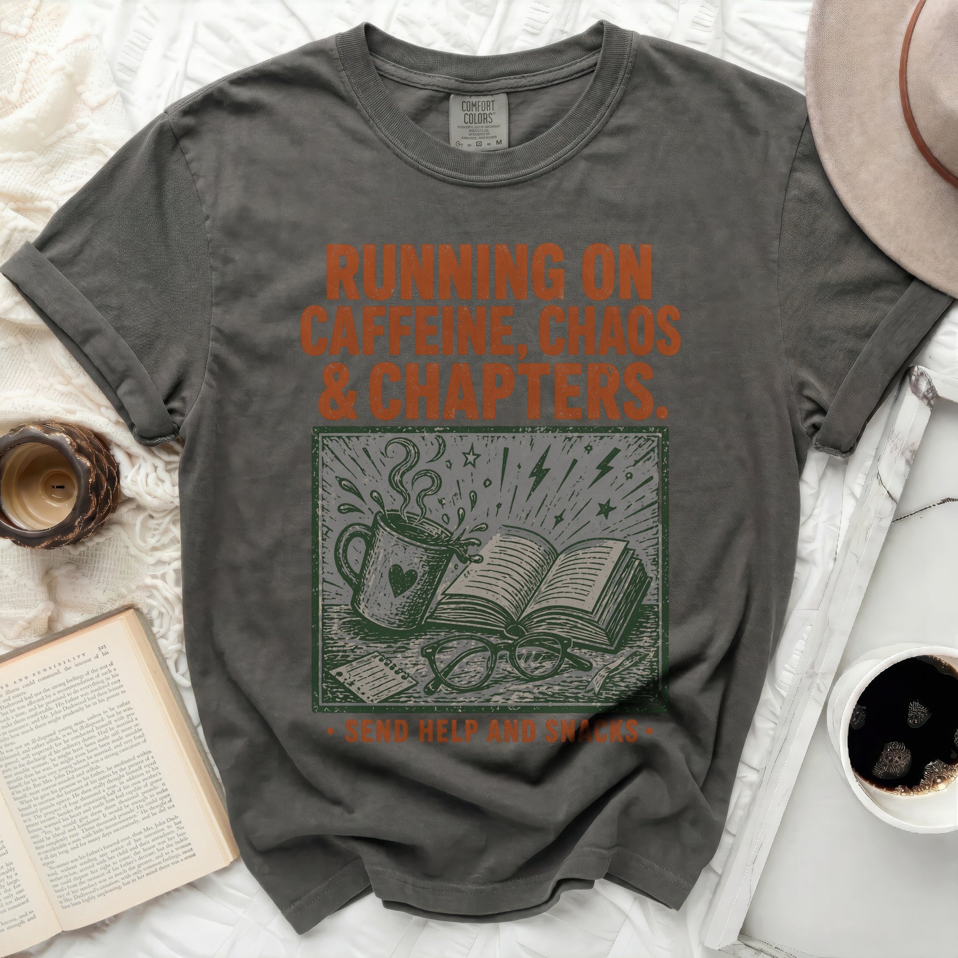Dark grey t-shirt with "Running on Caffeine, Chaos & Chapters" text and graphics.