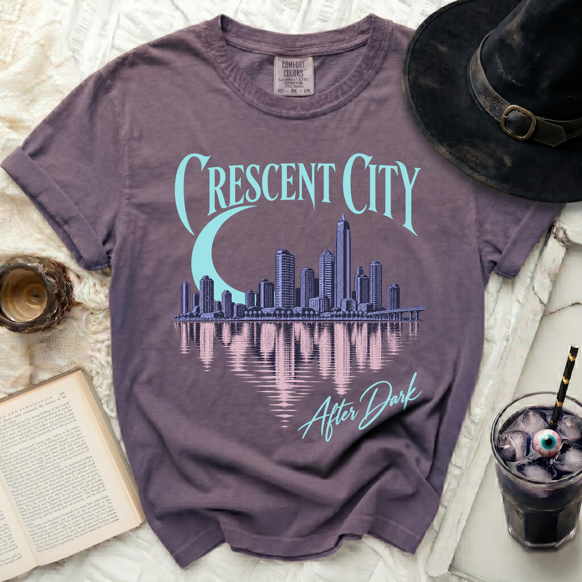 T-shirt with "Crescent City After Dark" text and a city skyline graphic.