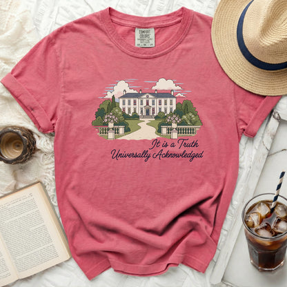 Salmon pink t-shirt with house and trees graphic and text: It is a Truth Universally Acknowledged