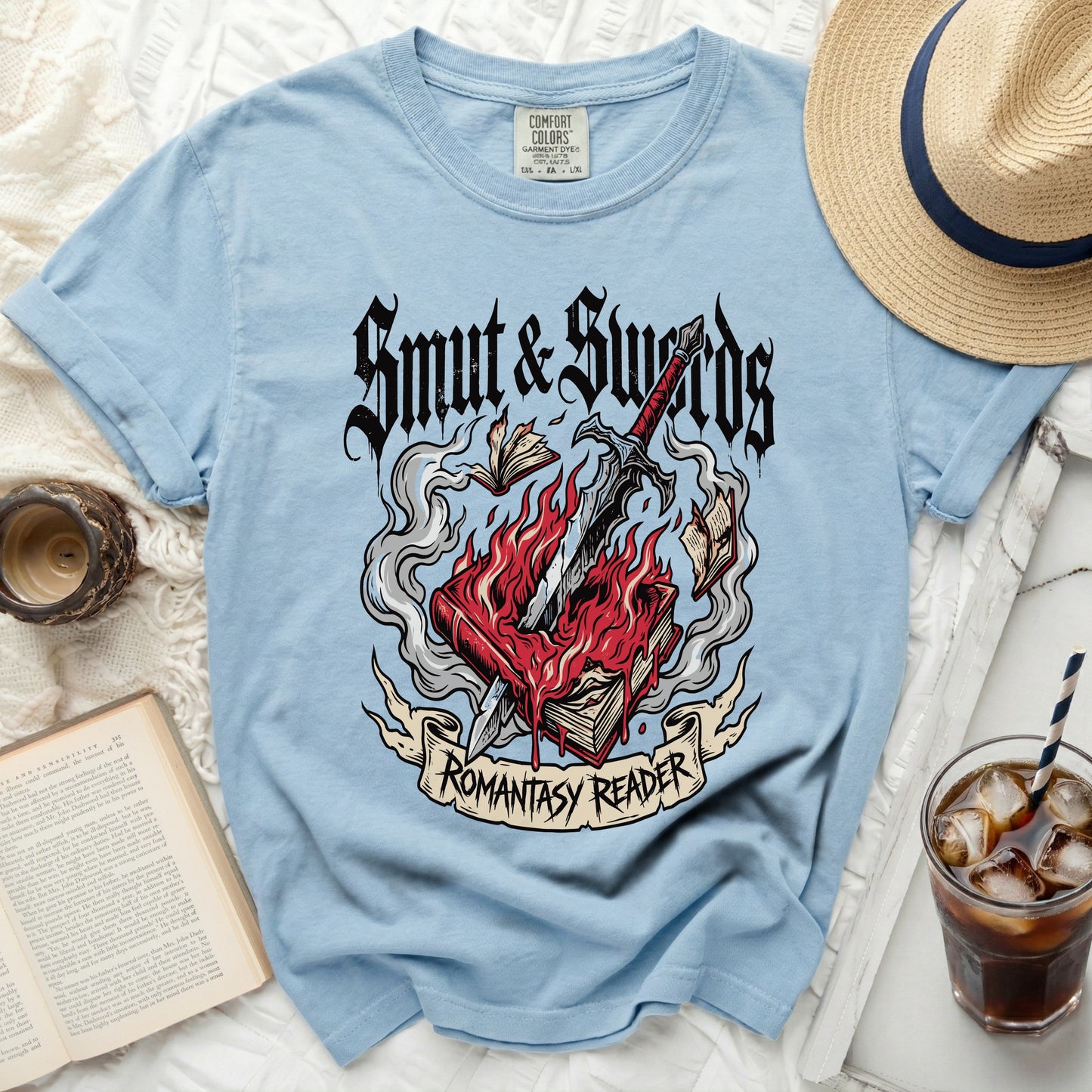 Blue t-shirt with "Smut & Swords Romantasy Reader" graphic.