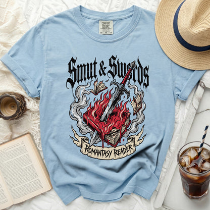 Blue t-shirt with "Smut & Swords Romantasy Reader" graphic.