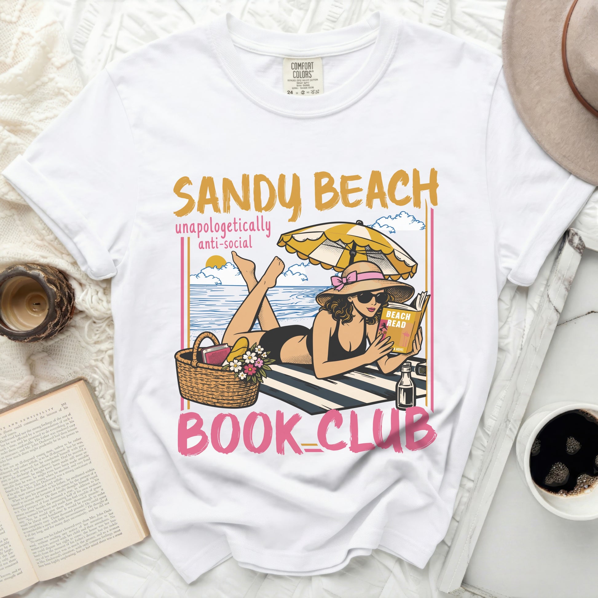 White t-shirt with "Sandy Beach Unapologetically Anti-Social Book Club" graphic.