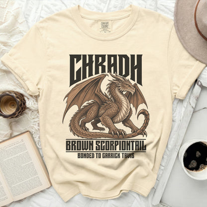 Tan t-shirt with dragon graphic and text "CHRADH BROWN SCORPIONTAIL BONDED TO GARRICK TAVIS".