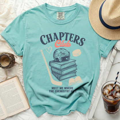 Teal t-shirt with "Chapters Club" graphic and hockey imagery.