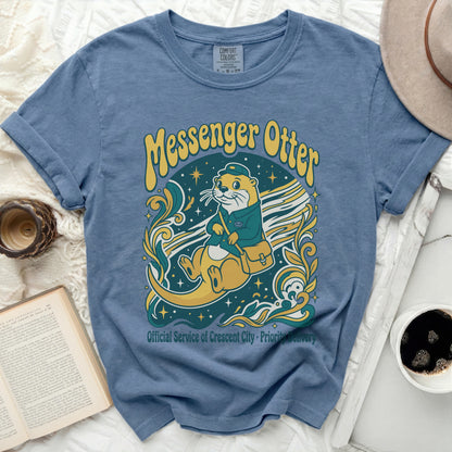 Blue t-shirt featuring a messenger otter illustration with text.