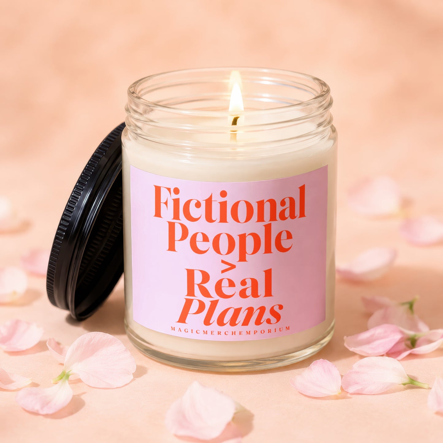 Candle with text "Fictional People > Real Plans" surrounded by pink petals.