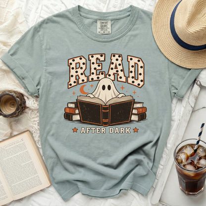 Ghost reading a book under moon and stars, "READ AFTER DARK" text.
