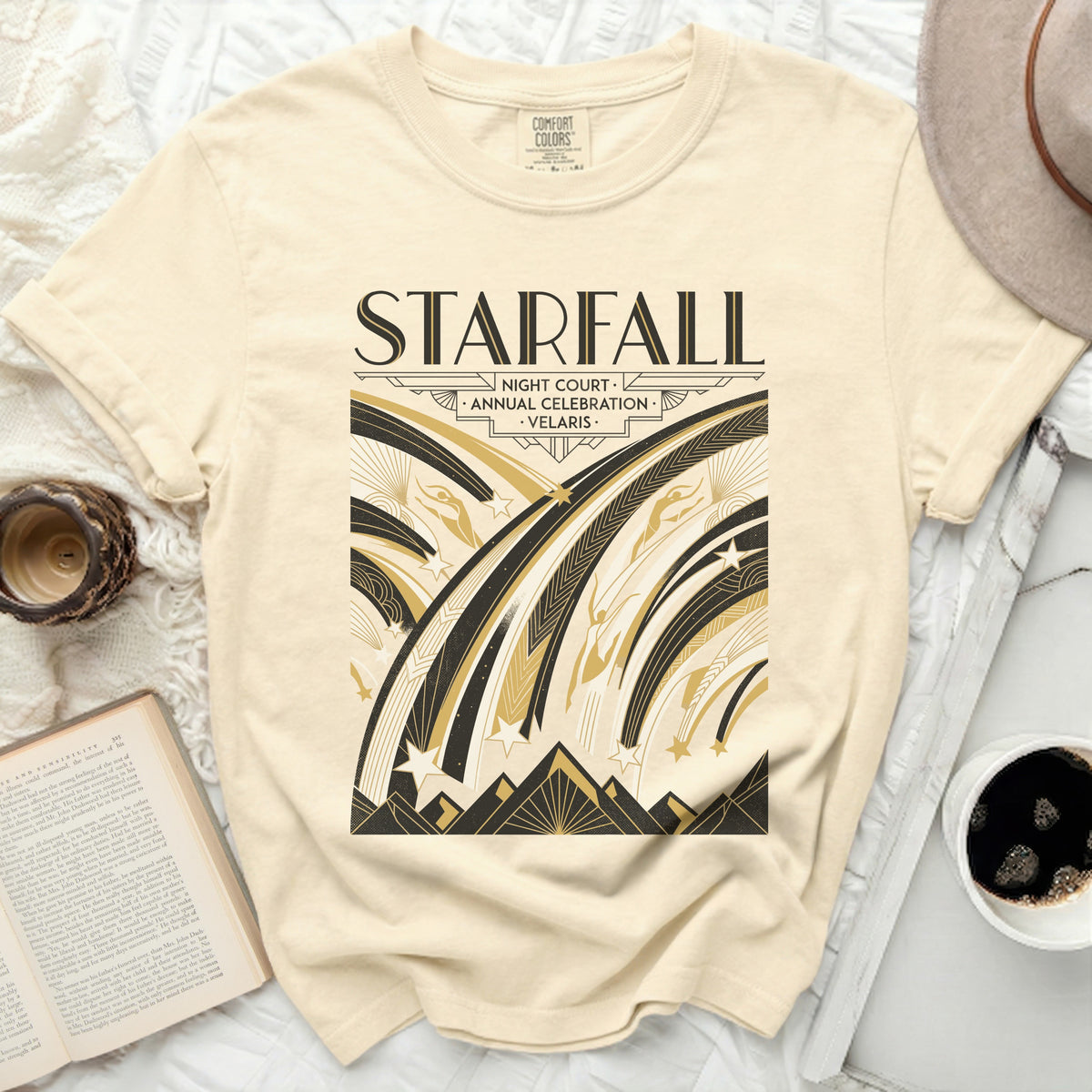 Cream t-shirt with "STARFALL NIGHT COURT ANNUAL CELEBRATION VELARIS" graphic.