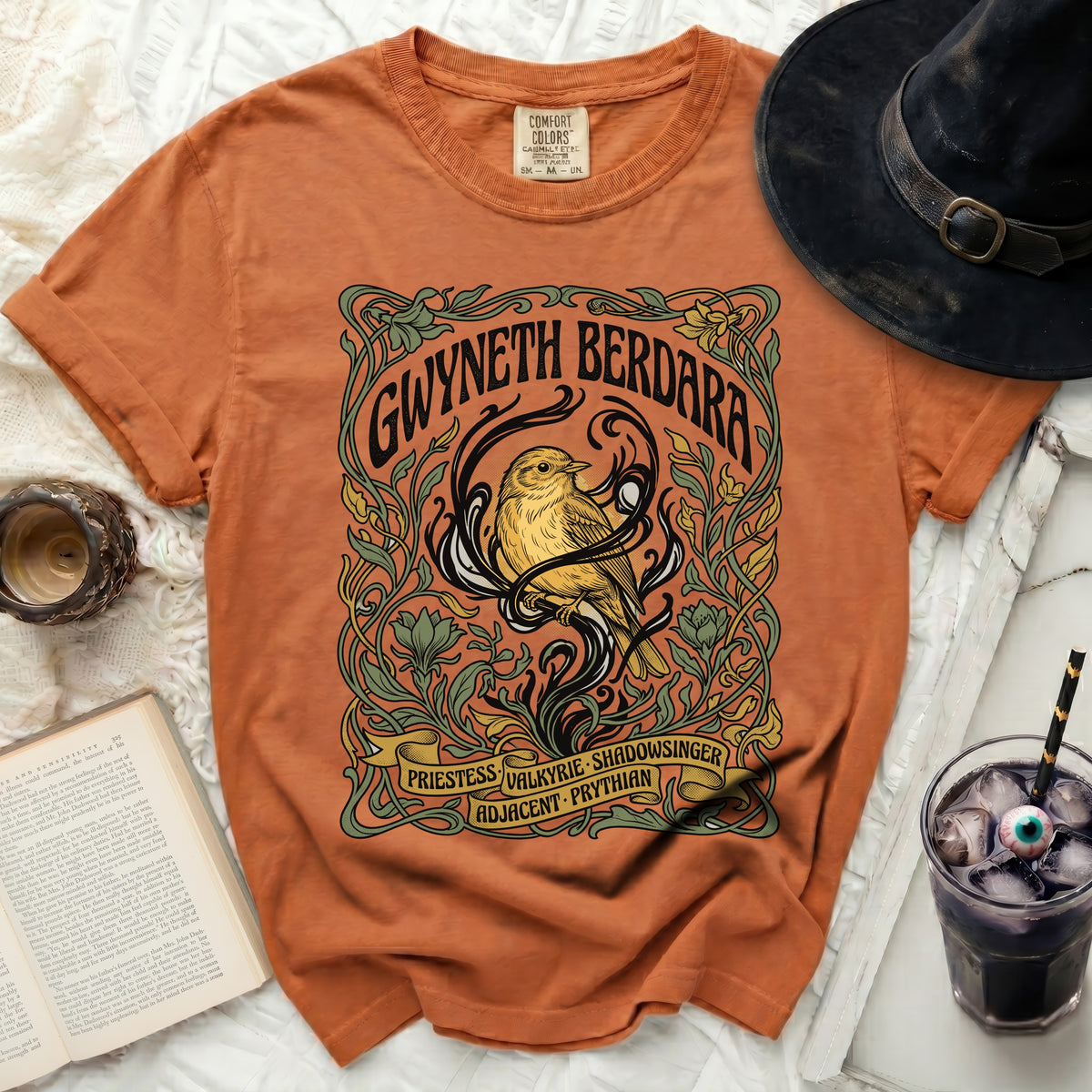Orange Comfort Colors t-shirt with "Gwyneth Berdara" bird artwork and text.