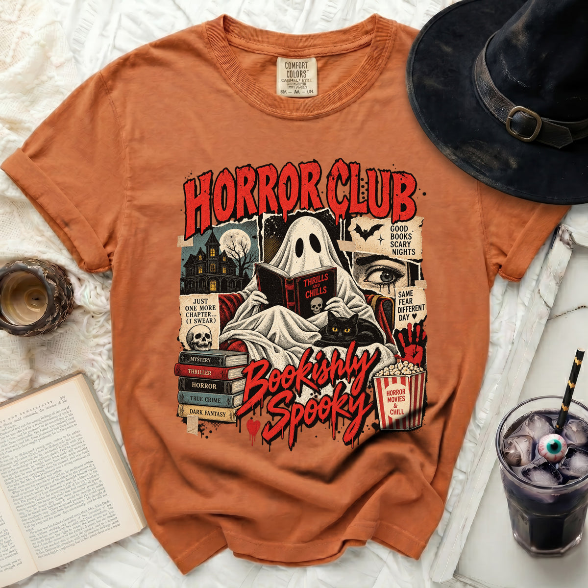 Horror Club ghost reading "Thrills and Chills" with black cat and books.