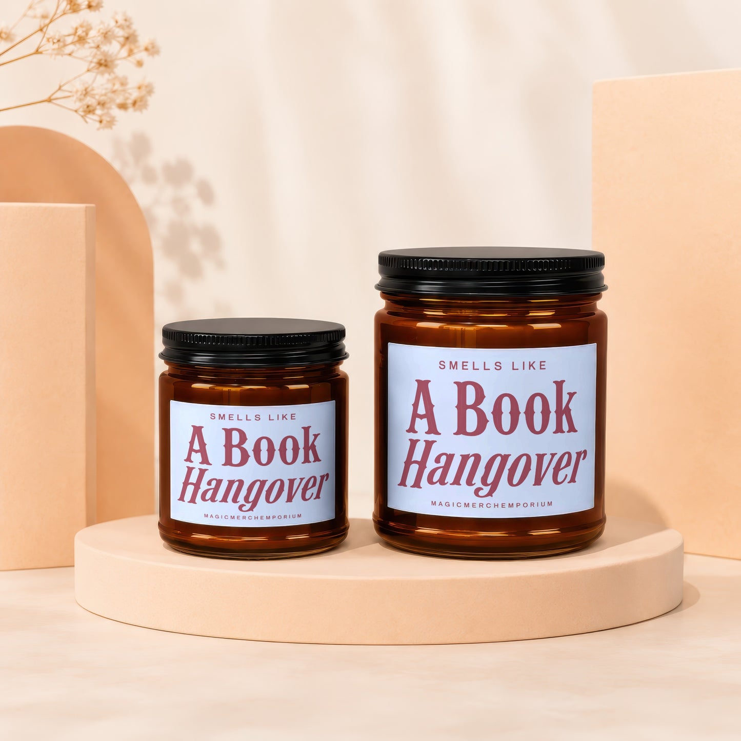 Two "Smells Like A Book Hangover" candles on display pedestals.