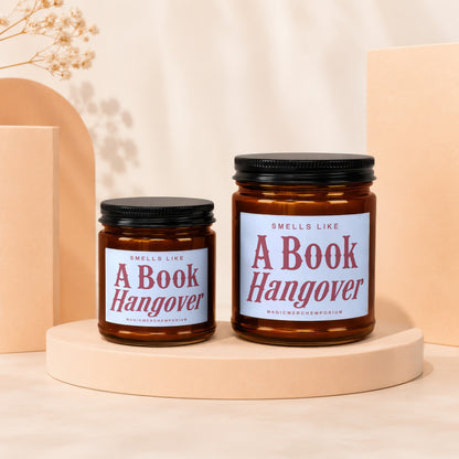 Two "Smells Like A Book Hangover" candles on display pedestals.