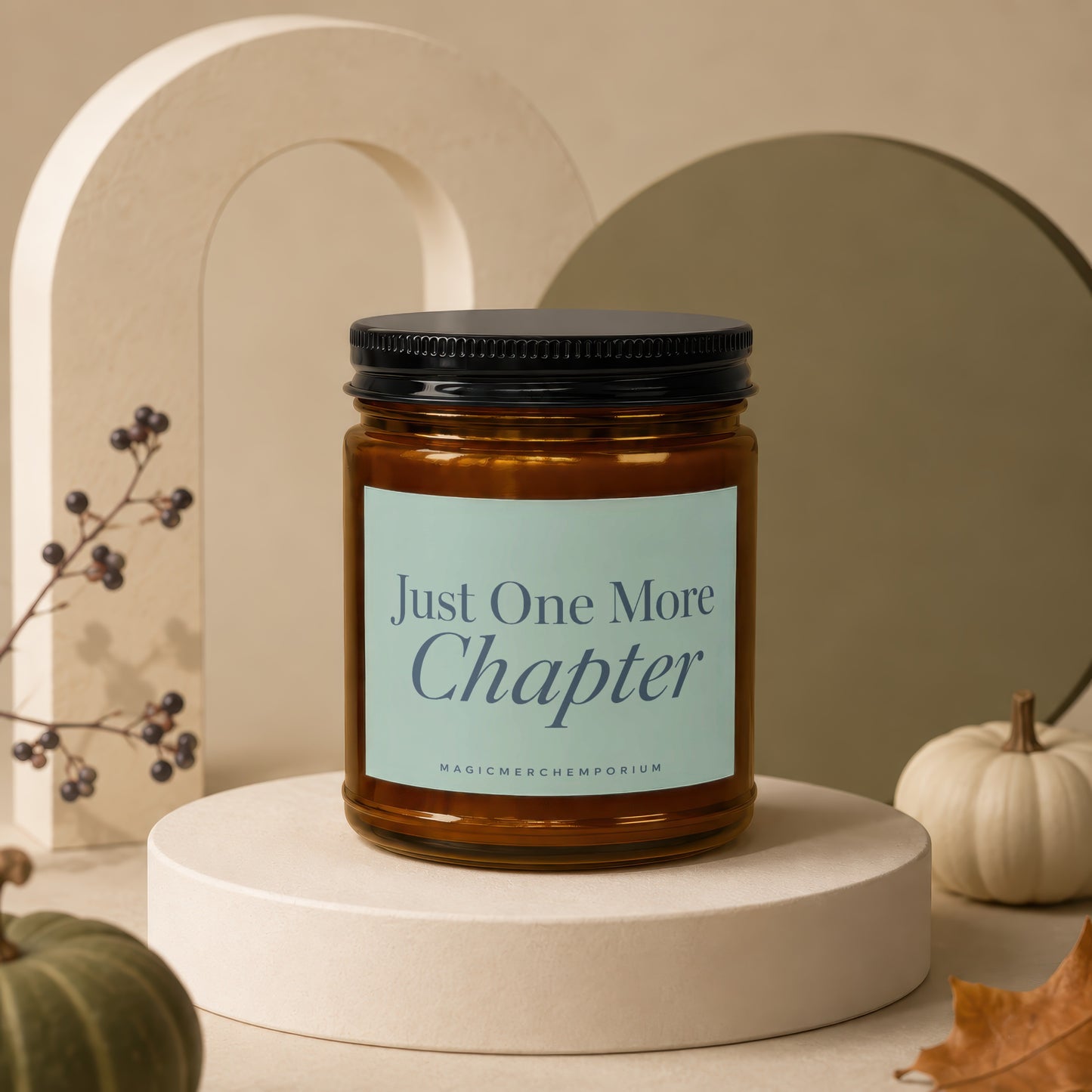Amber jar candle with black lid reading "Just One More Chapter".