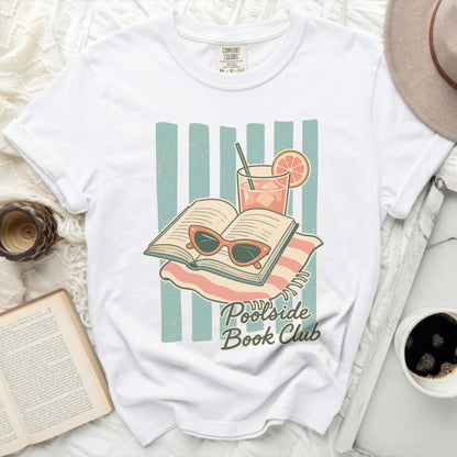 T-shirt graphic of an open book, sunglasses, and drink with "Poolside Book Club" text.