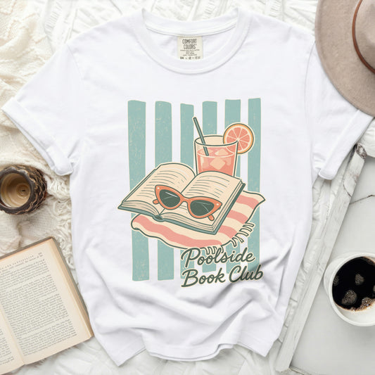 T-shirt graphic of an open book, sunglasses, and drink with "Poolside Book Club" text.